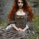 Beautiful historical woman with red curly hair.